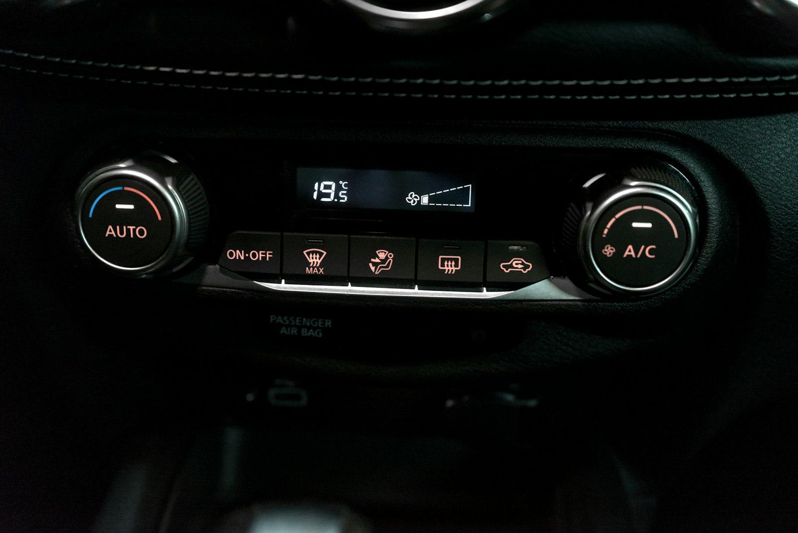 Car climate control panel with A/C, auto, and front and rear defrost buttons