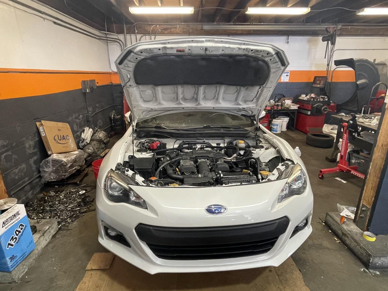 Car with the hood open in a service bay at 415 Mechanix in Potrero Hill